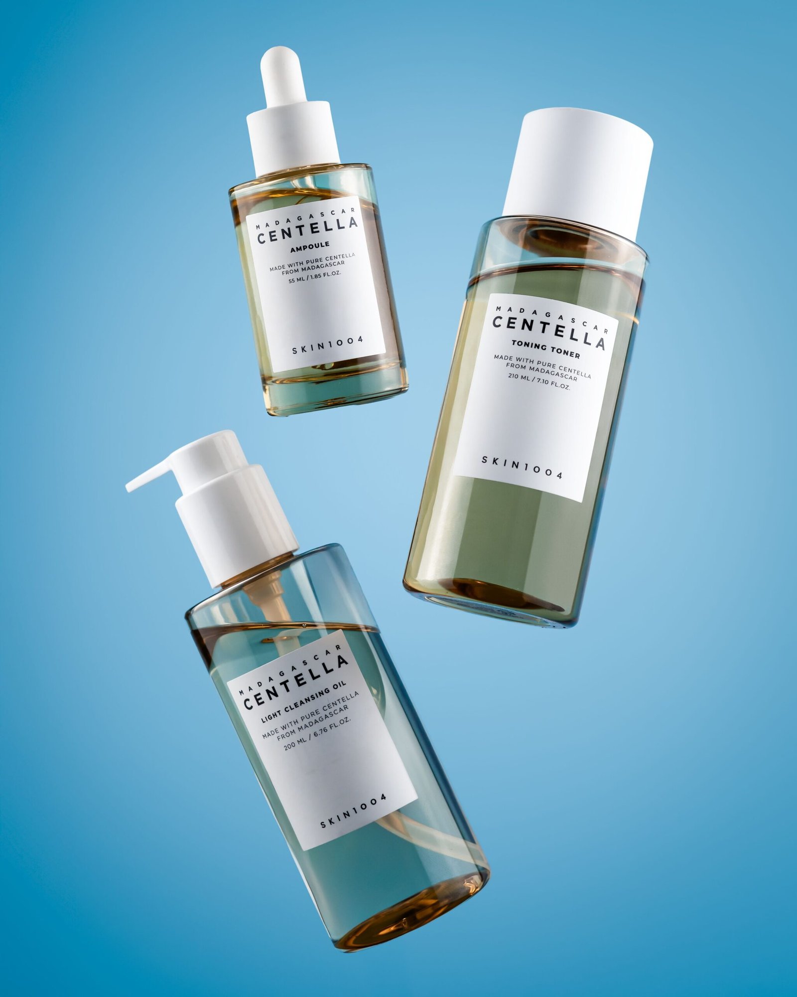 Centella skincare products floating in the air against a blue ambient-lit background.